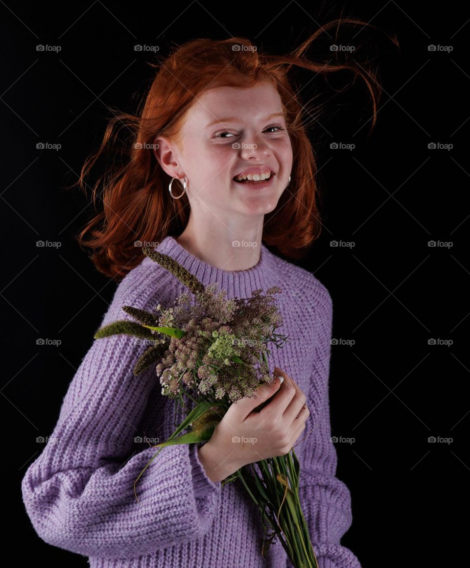 Smiling ang happy girl,laugh and having fun in front of the camera.
Dark light and dark background .