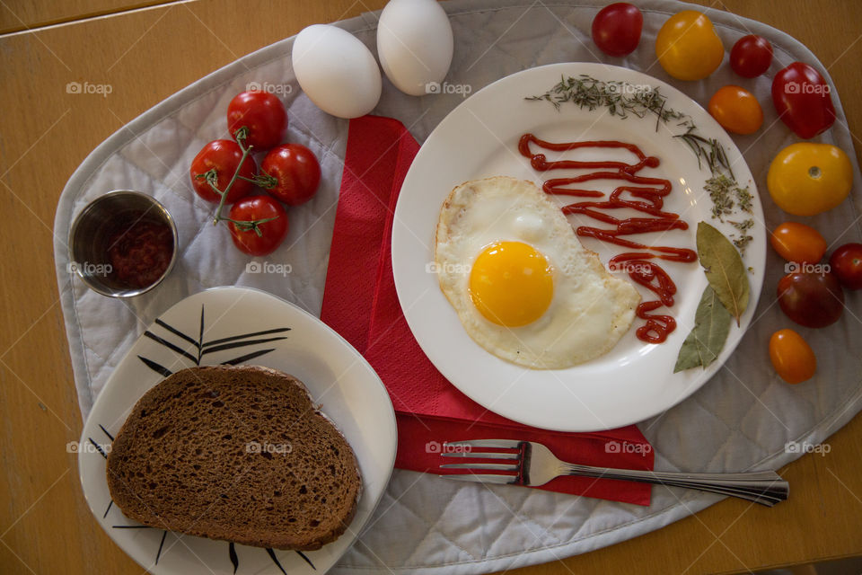 Eggs, tomatoes and bread in a beautiful bright flat lay