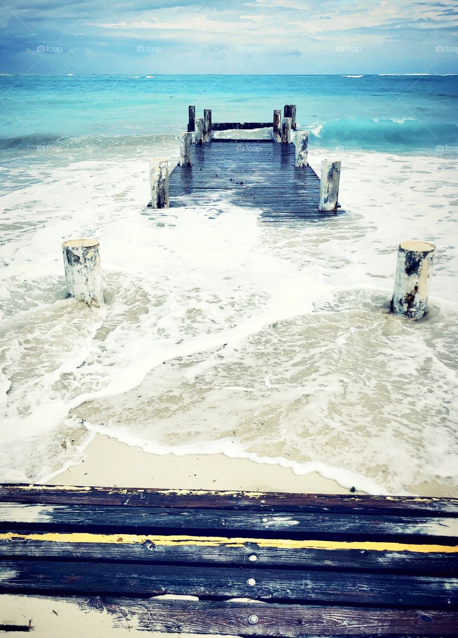 Stormy weather causing flooding damage on wooden pier and walkway