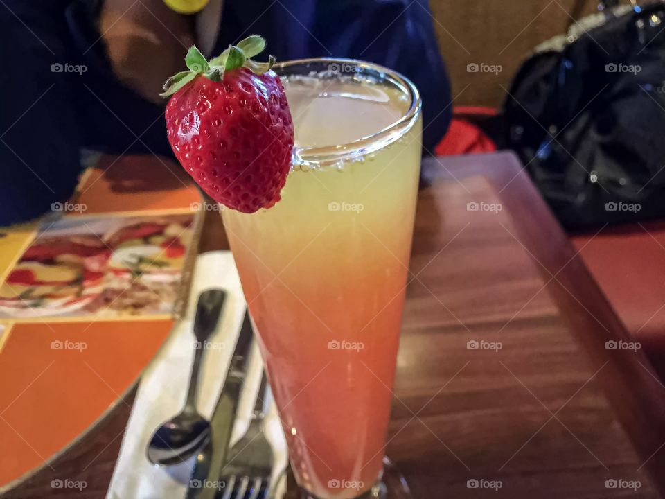 A delicious looking drink with a strawberry to top it all off