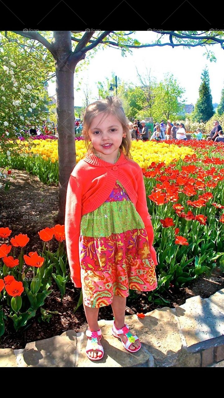 Little Girl in front of tulips