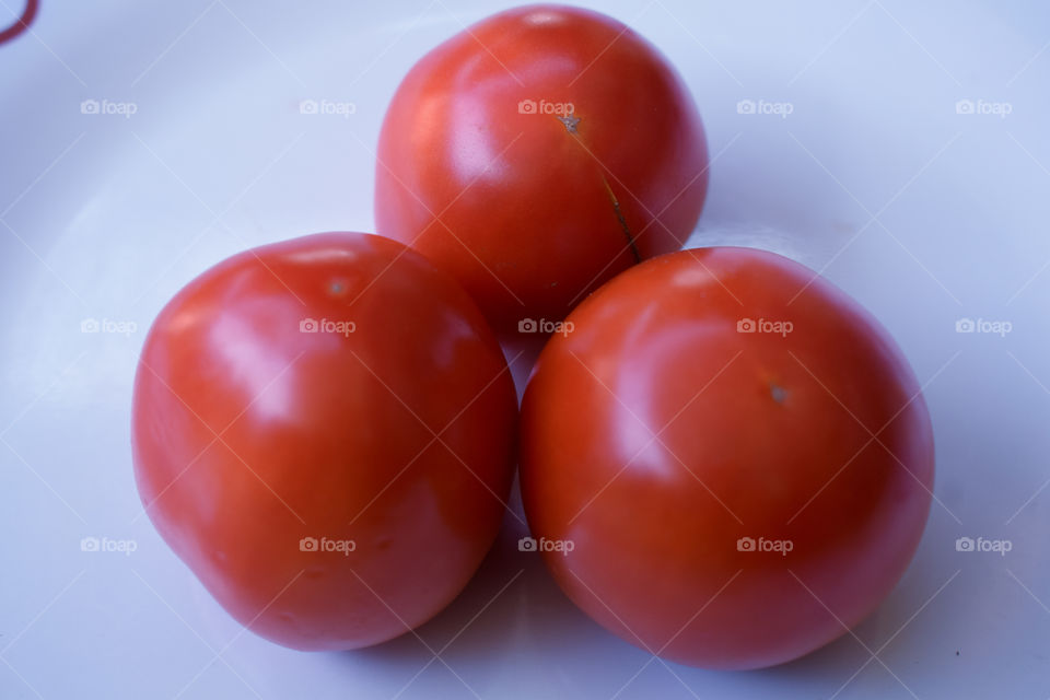 three tomatoes on a plate