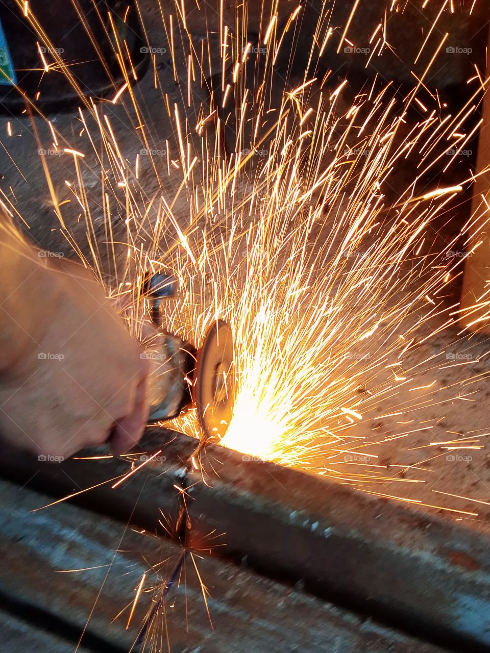 technician cutting steel, fire sparkle