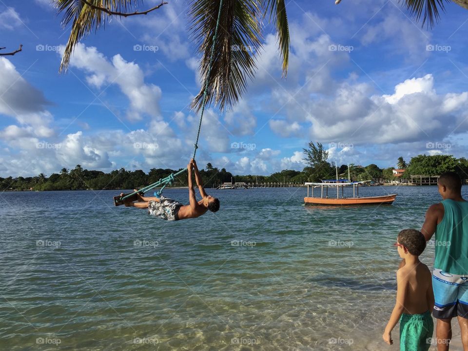 Boys having fun in the tranquil sea in Brazil