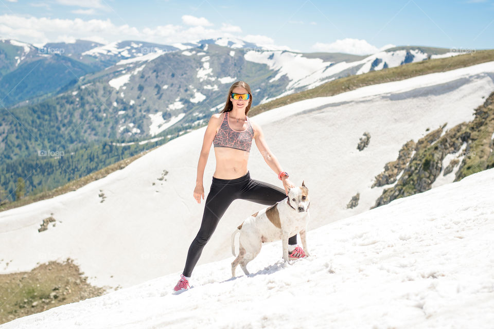 woman with a dog in the snow in summer