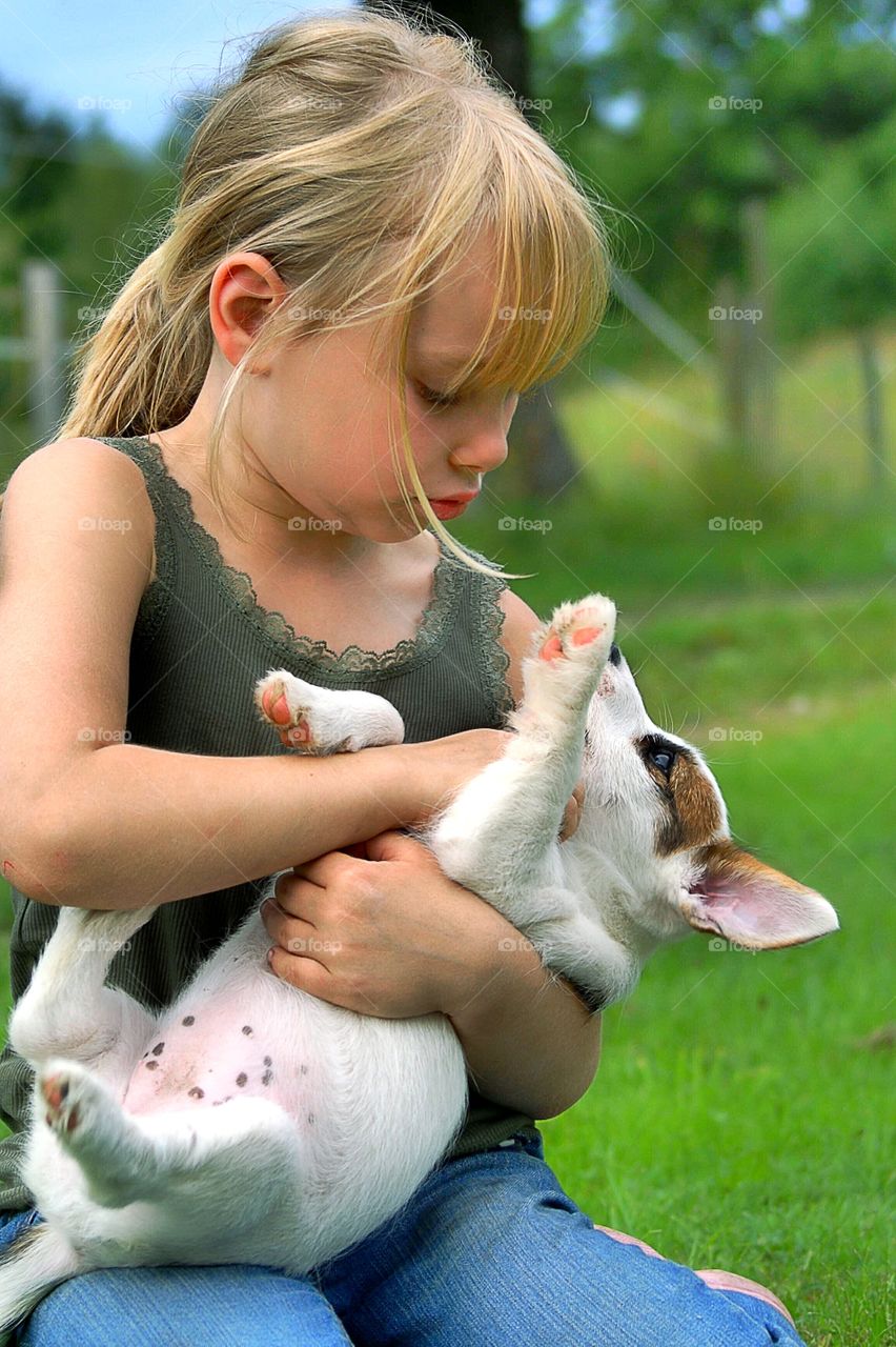 Girl cuddling with a puppy