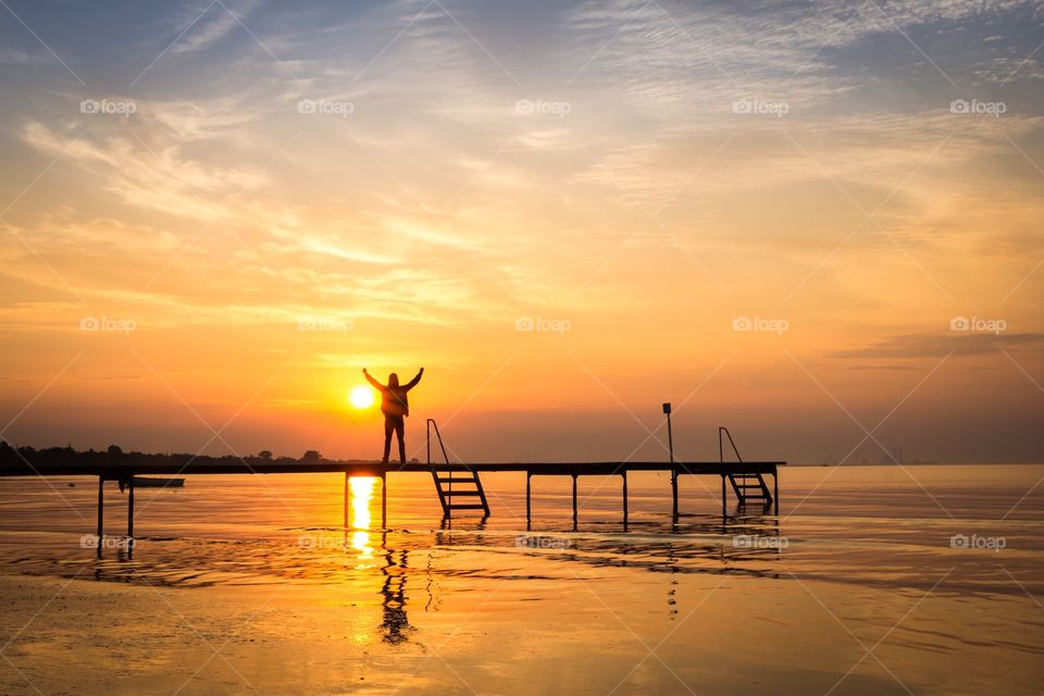 Sunrise Man standing at the Beach
