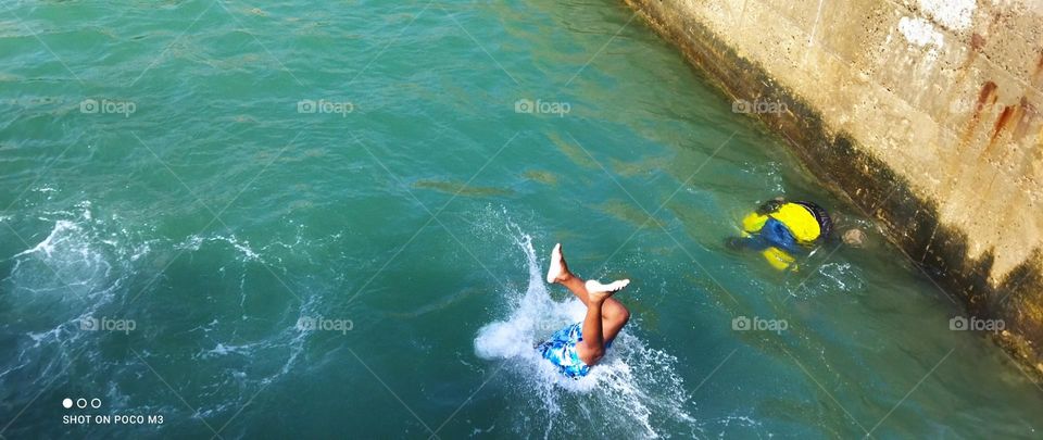 splendid jump into water at essaouira Harbour in Morocco.