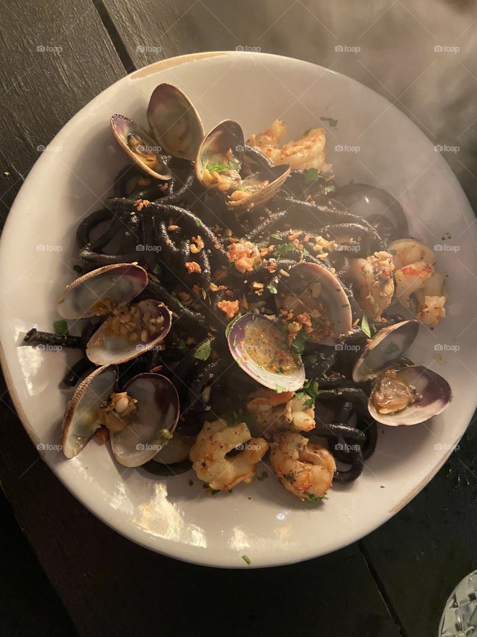 Delicious squid ink pasta with clams and shrimp, in a garlic, lemon, chili, caper sauce!