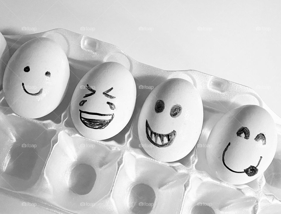 Emoji eggs white eggs in a white carton 