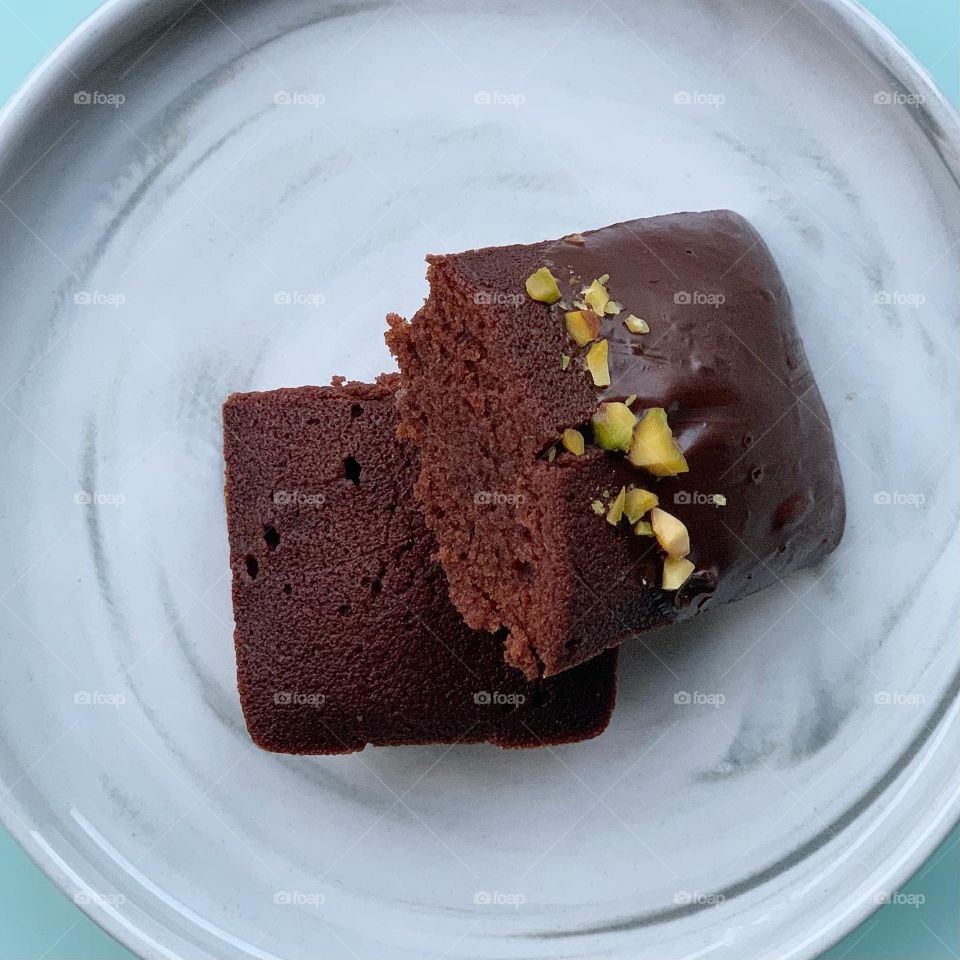 French patisserie financiers in four different flavours - brown butter, dark chocolate, black sesame and yuzu against a natural background