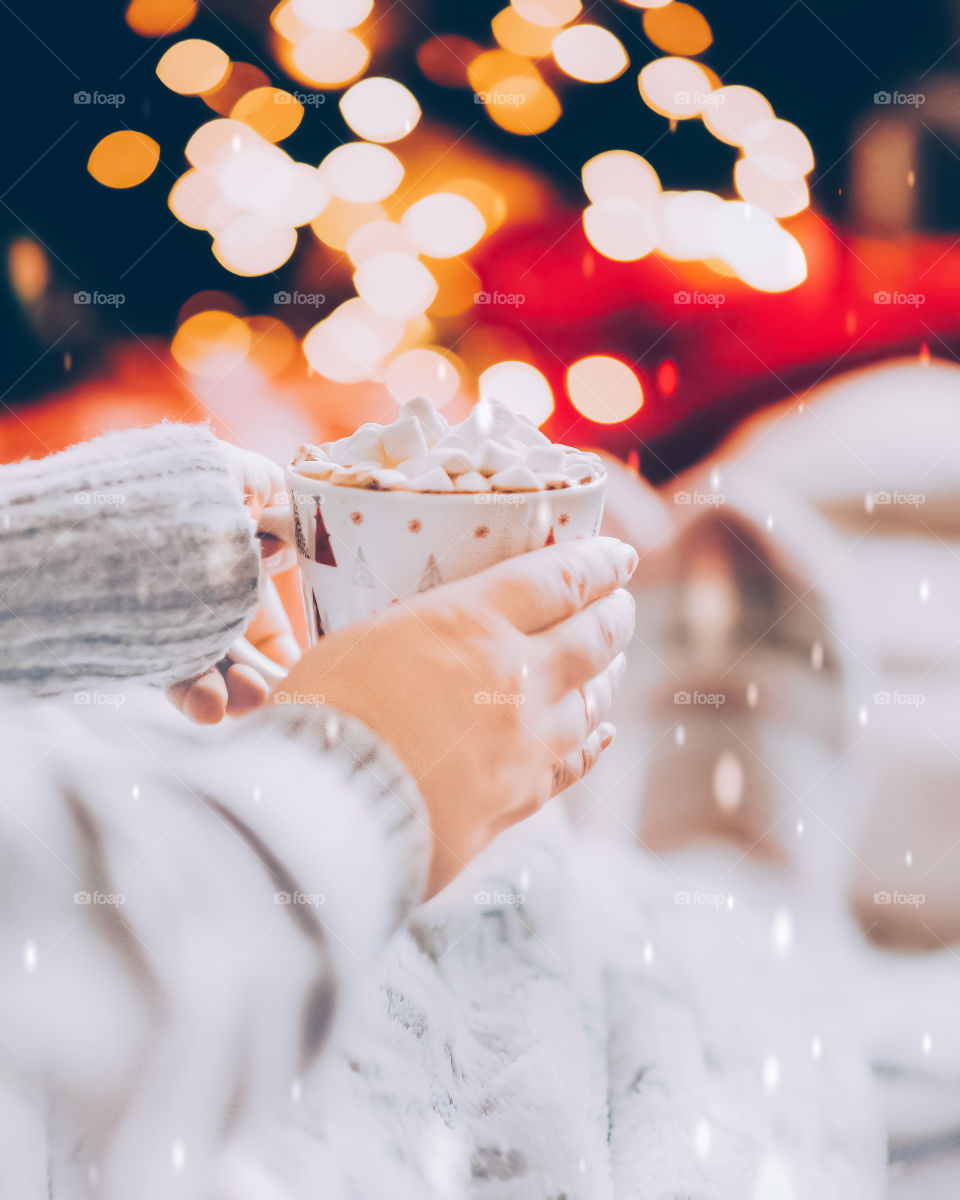 Christmas drink with marshmallows. Winter coffee. Christmas lights.