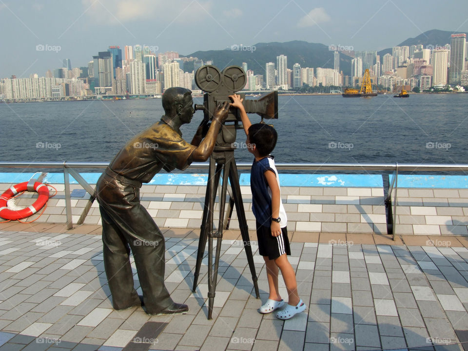 Boy standing near binoculars