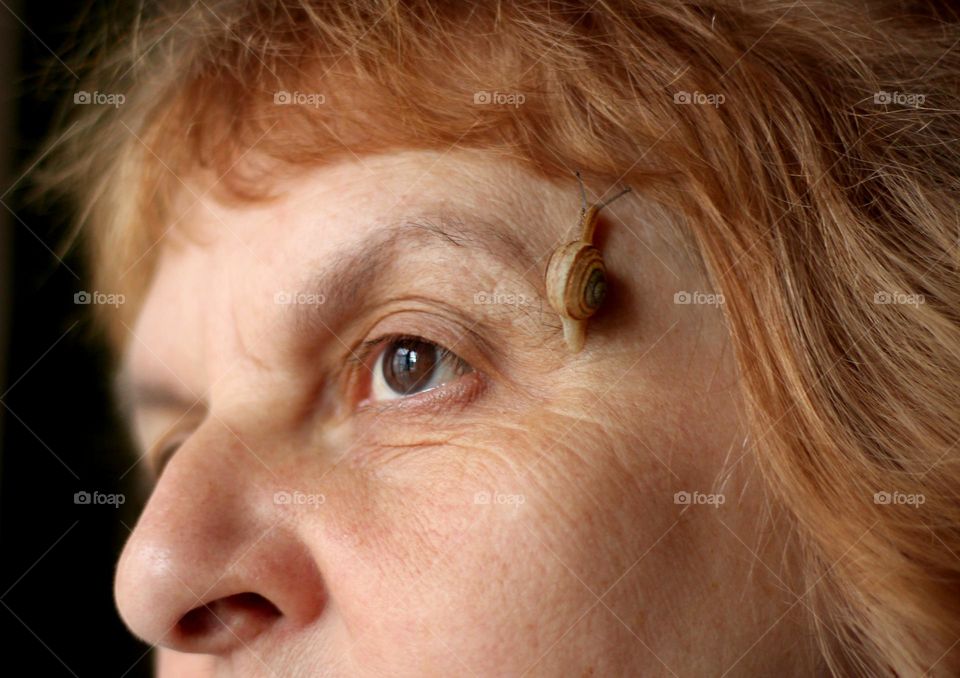 Snail on woman's face