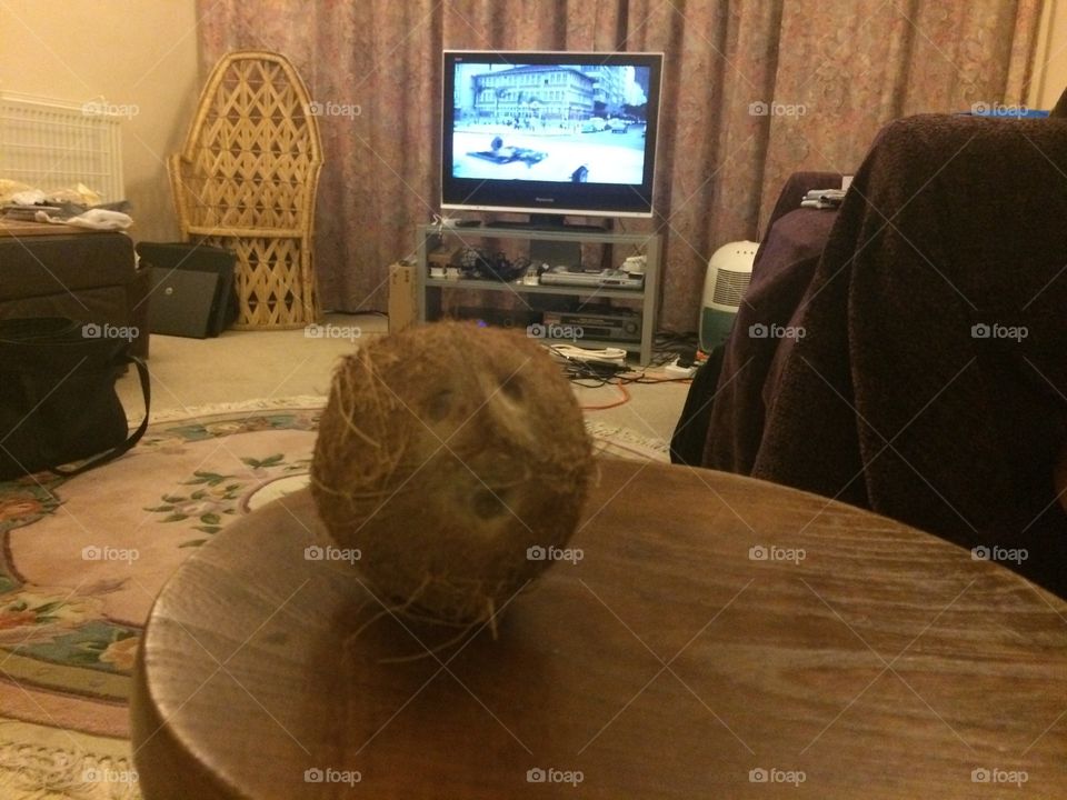 Coconut face . Face on a coconut while watching TV