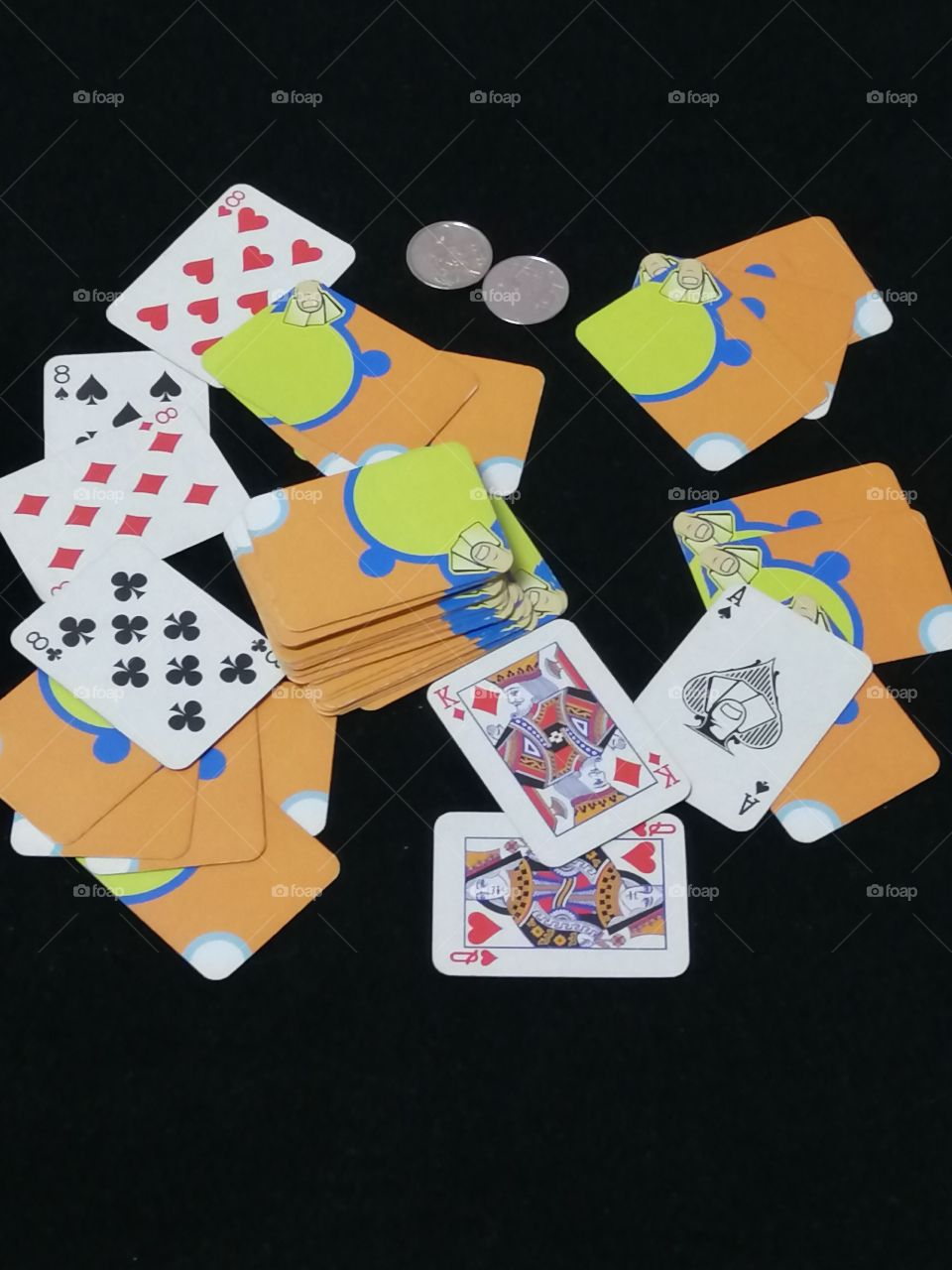 Miniature playing cards and 2 5-centavo coins