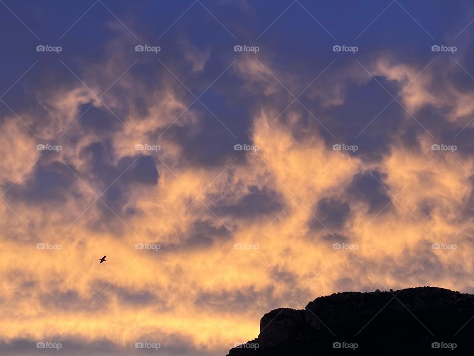 Clouds illuminating sunset sky