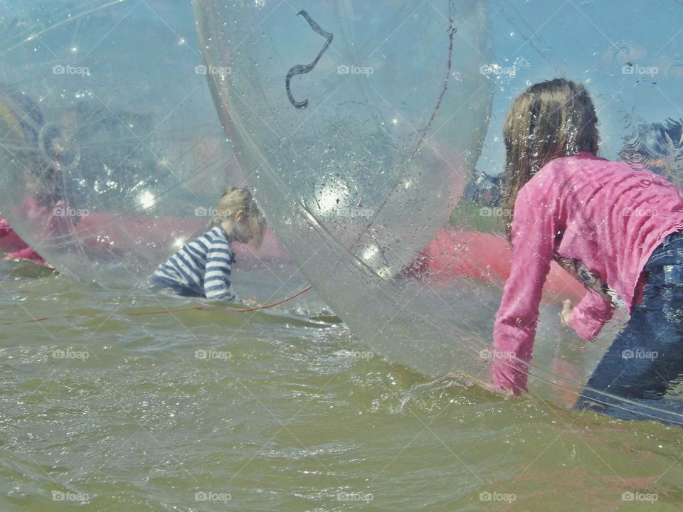 Children in plastic balls