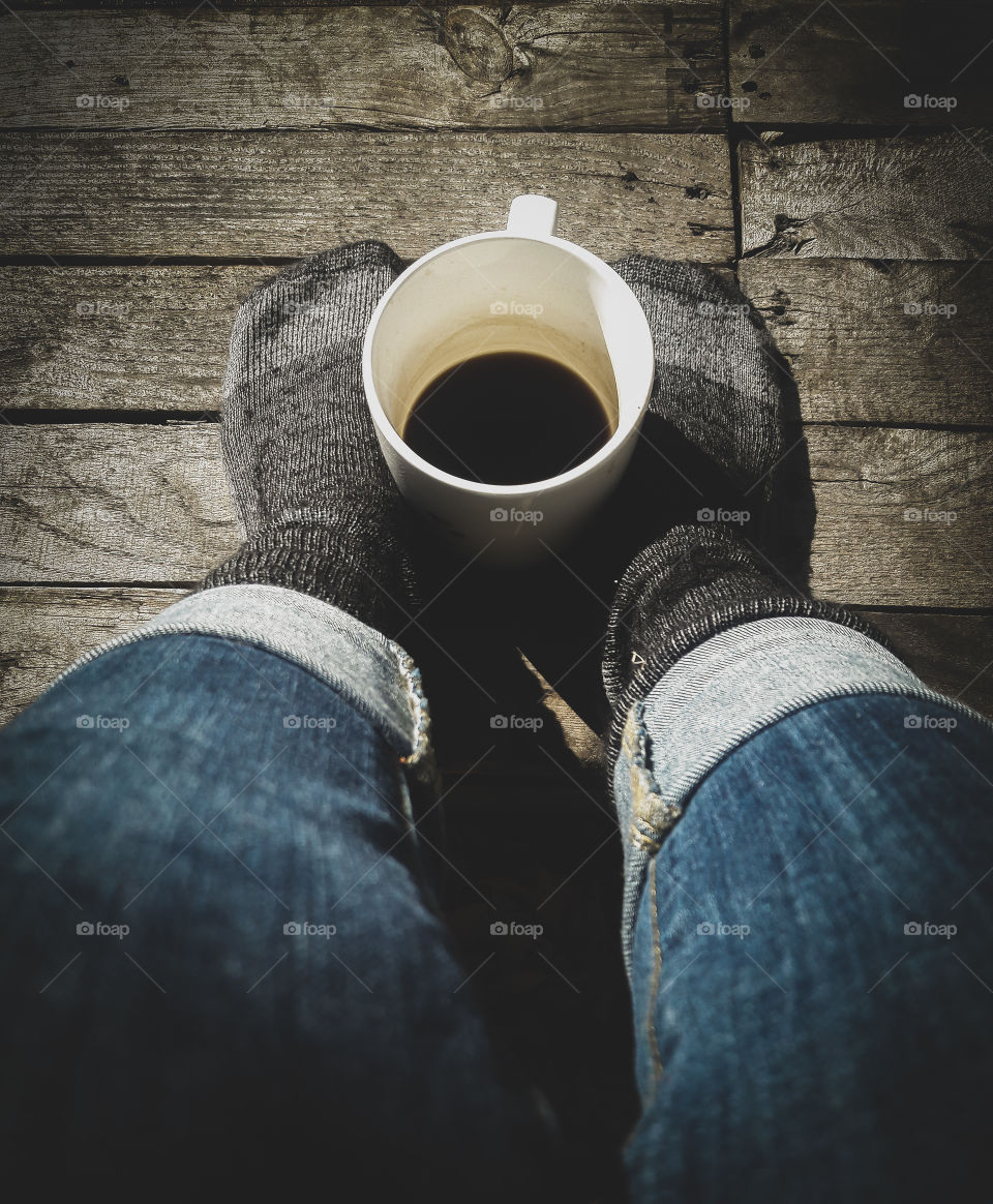 shoes off relaxing outside with coffee