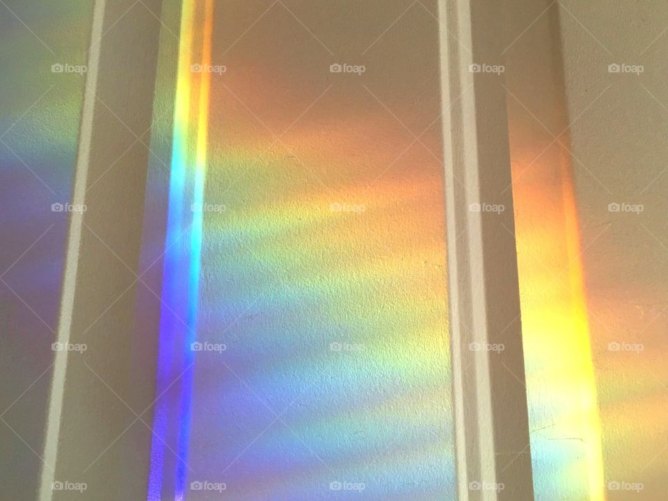 Rainbow spectral light refracting from a crystal prism.