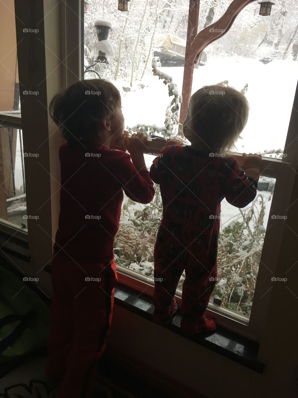 The sight of the first snow delights two children. 