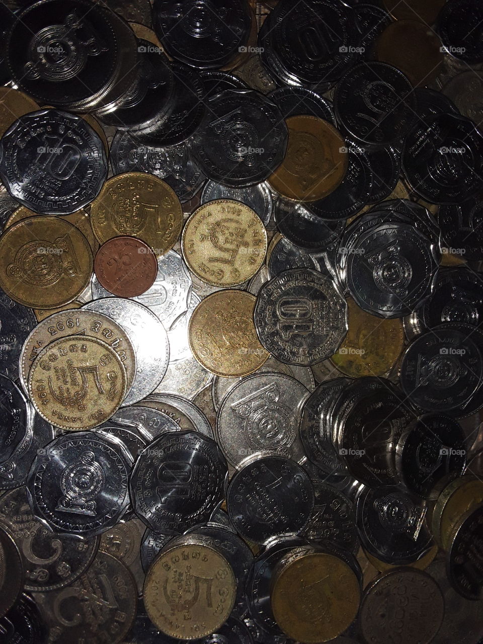 A coins is a small flat (usually depending on the country or value) round piece of meal or plastic used primarily as a medium of exchange or legal tender. they are standardized in weight and produced in large quantities.