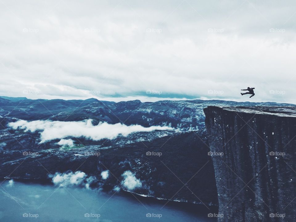 Nothing is impossible. Jumping on the top of Prekestolen rock in Norway.