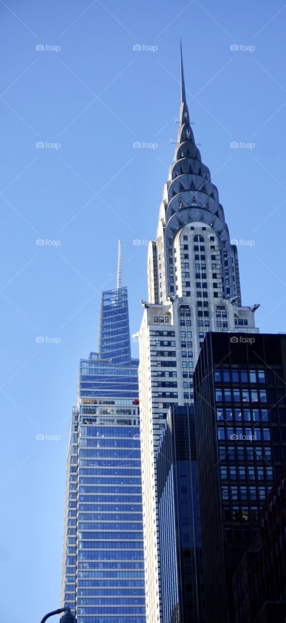 Architecture historic and new. One Vanderbilt 2019 office tower rises next to the 1930 Art Deco style Chrysler tower. Both beautiful in the skyline.