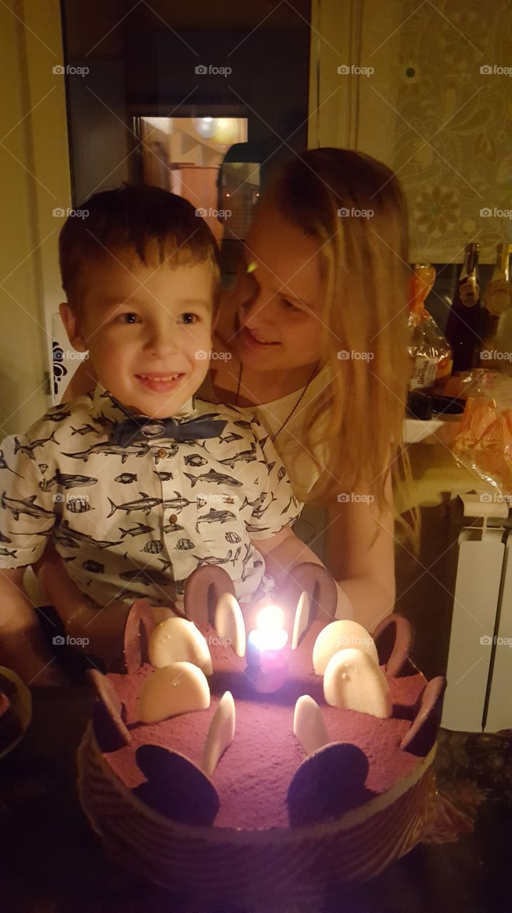 mother with her son at a birthday cake