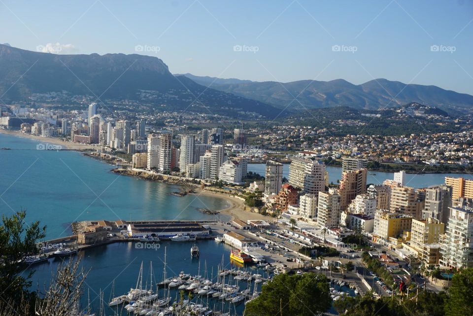 City#view#port#sea#buildings#boats#mountains