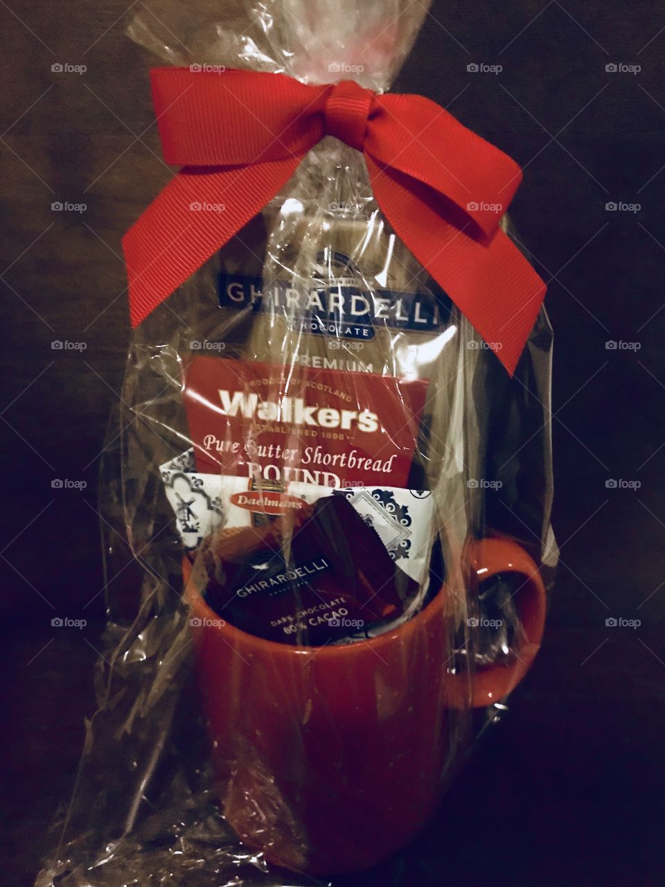  A beautiful and brightly decorated Christmas display of Ghirardelli chocolates and treats tied with a big red ribbon on top. USA, America 