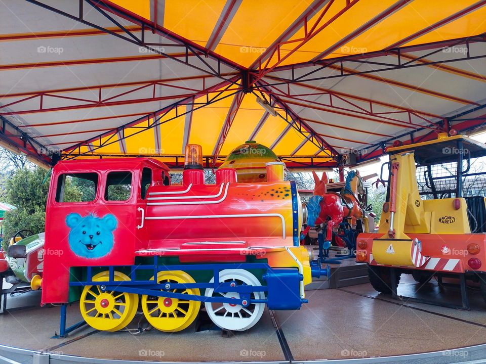 Colorful locomotive in the children's amusement.  Dominance geometric shapes: triangle, circles, and rectangle