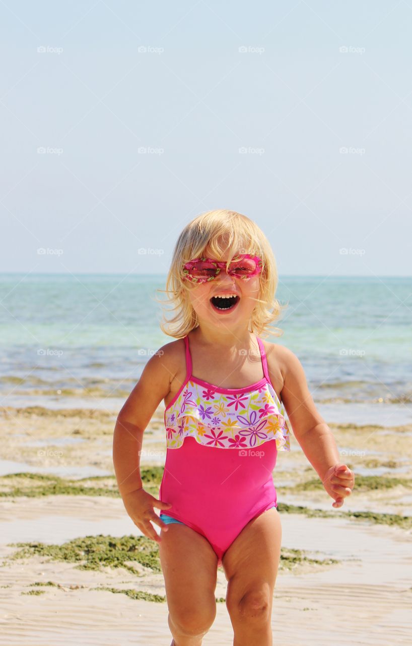 Happy little girl at beach