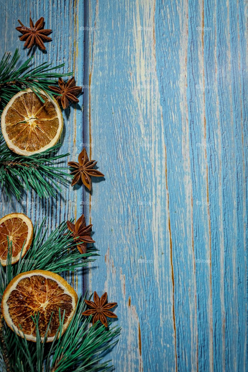 Christmas decorations for a card of dried oranges on a wooden table