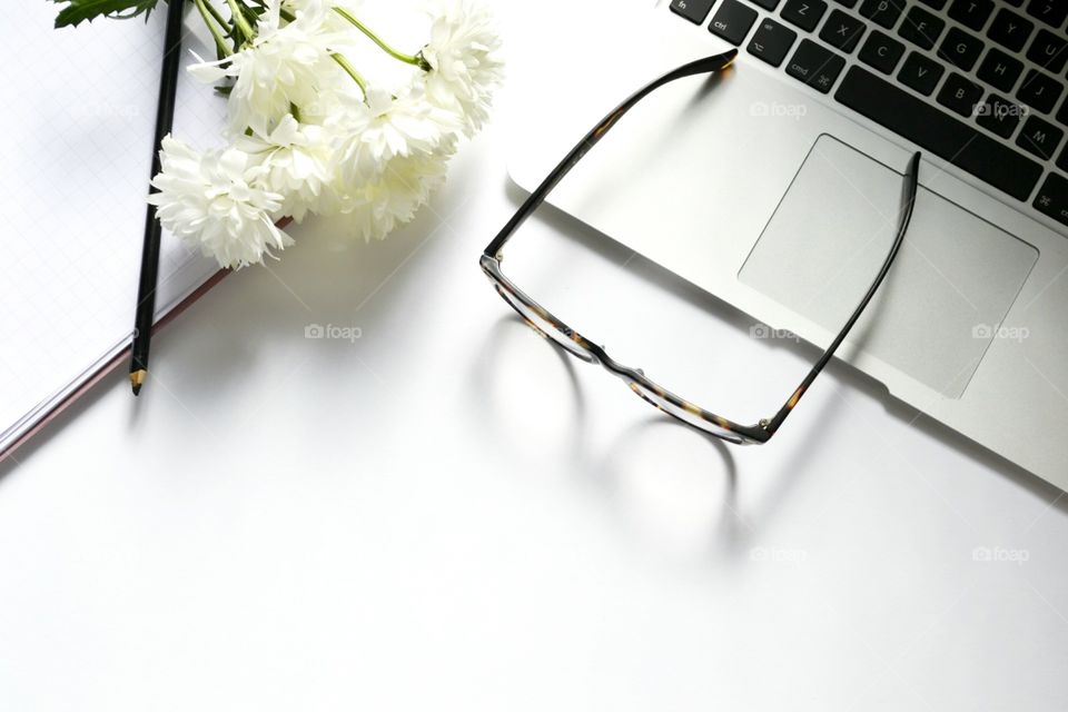 Macbook ,glasses and white flowers