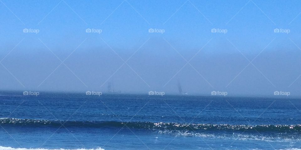 boats disappearing into fog