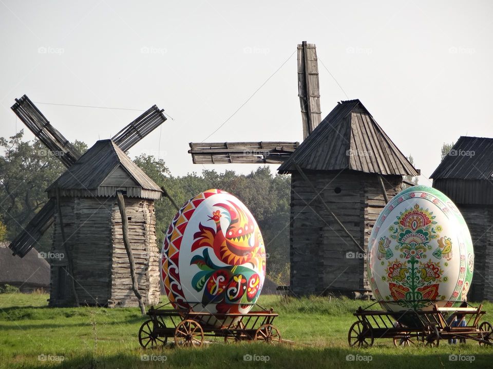 Large painted Easter eggs on the background of windmills