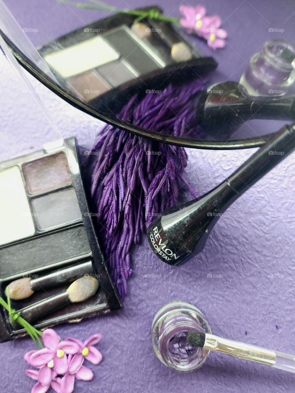 Purple themed makeup products.