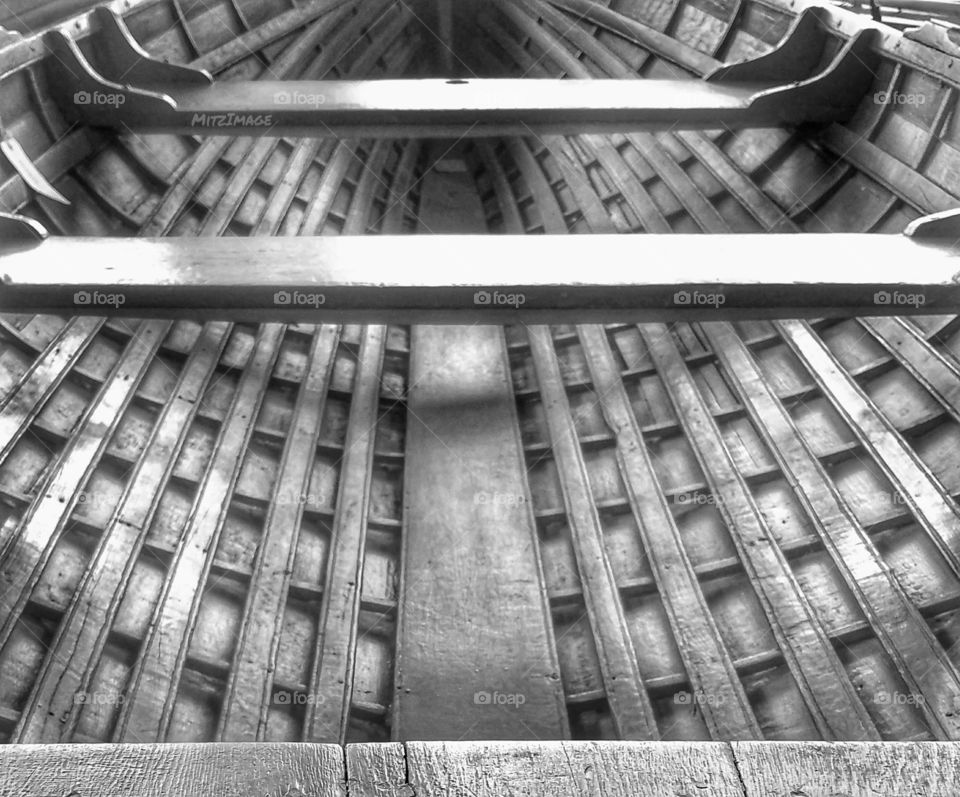 Inside a black & wite vintage wooden paddle boat.