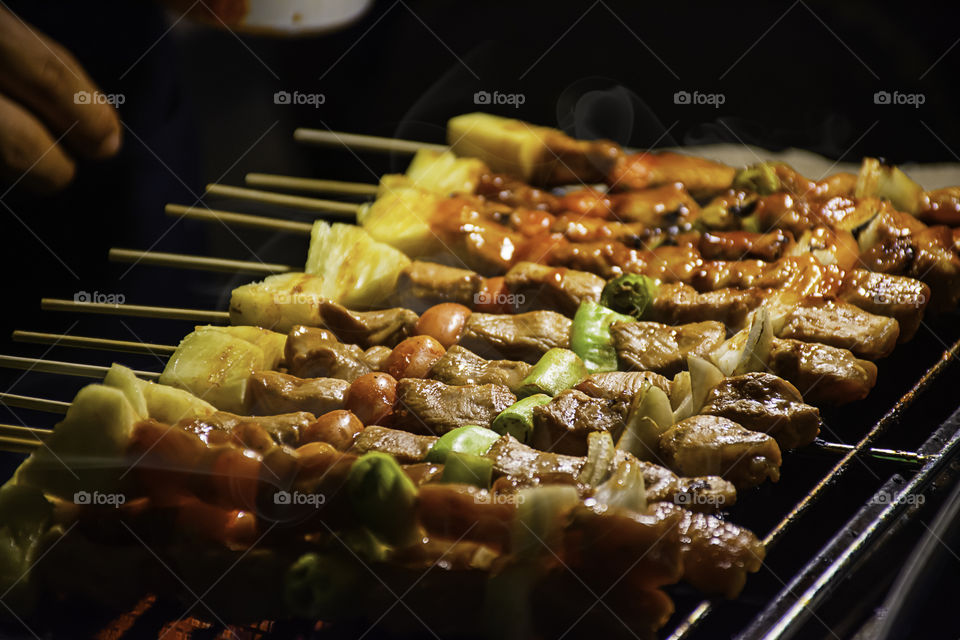 BBQ grilled meat with vegetables and tomato sauces on the steel grilles With the heat.