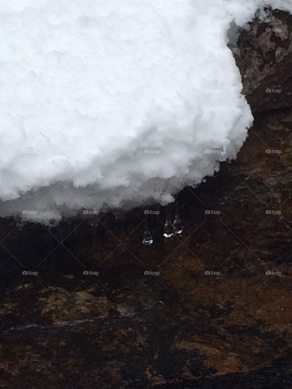 Icicles hanging over river bed
