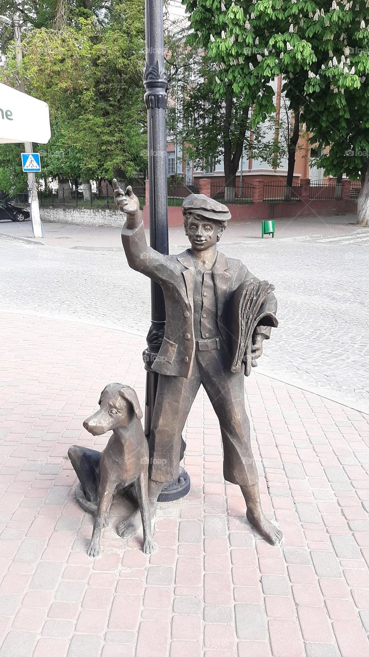 boys dog with street sculpture