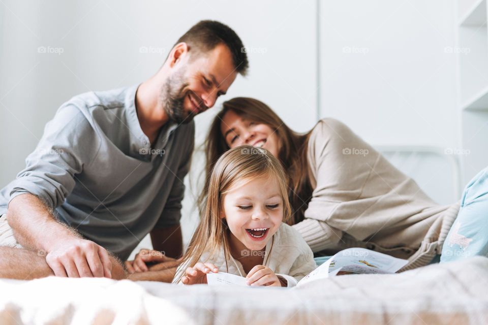 Happy family on bed at home 