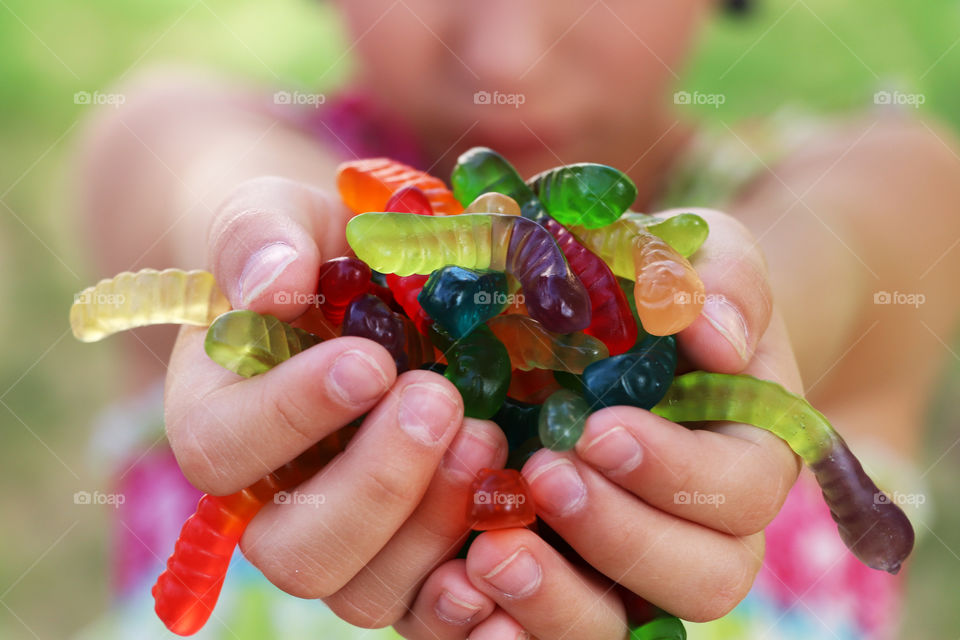 Child with a handful of gummi worms