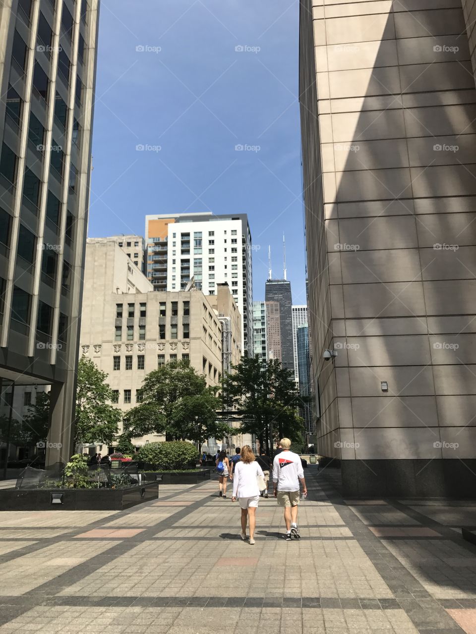 Couple walking in Chicago with the John Hancock Center in sight