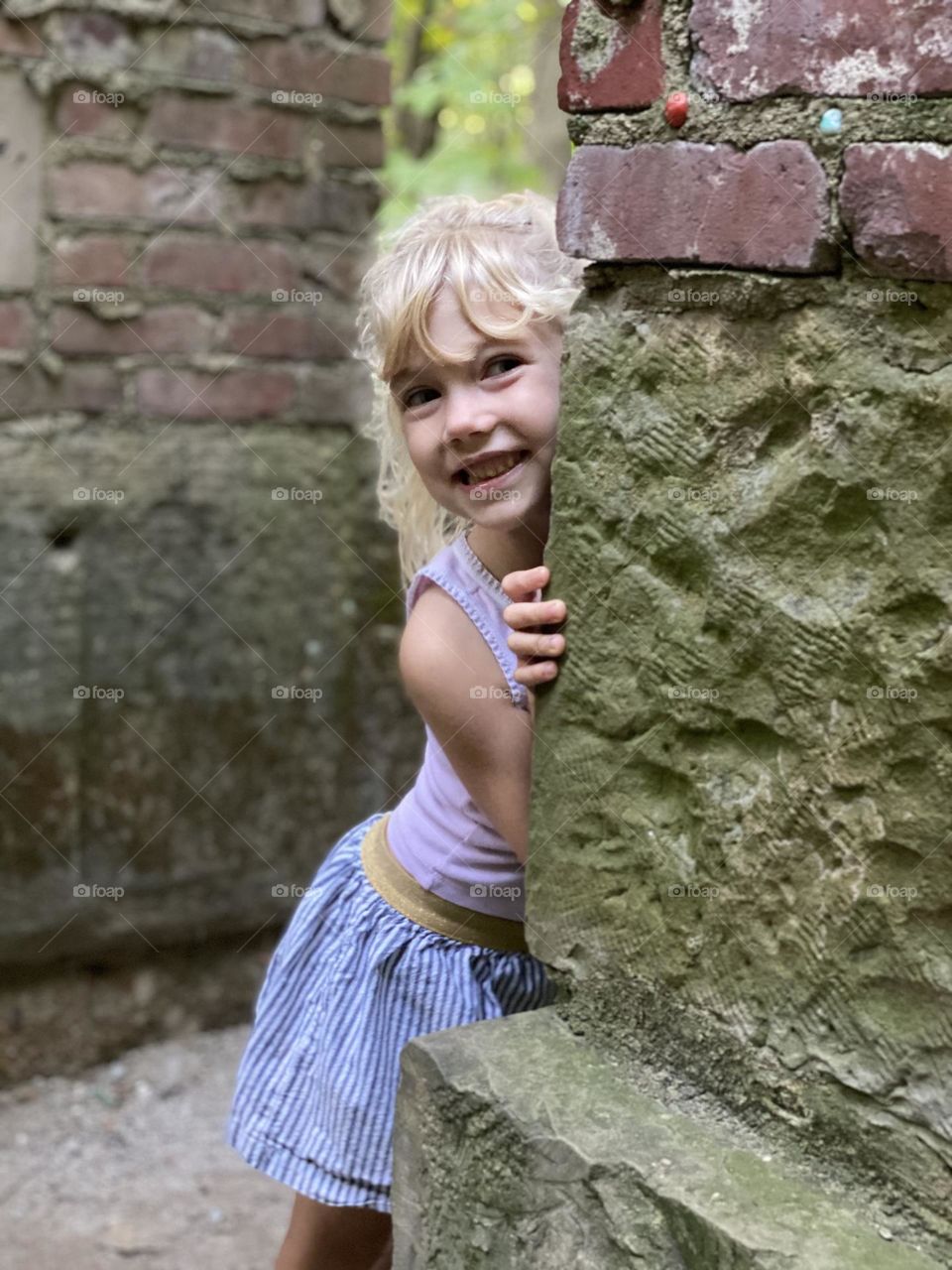 Playing hide and seek at a park on a summer day