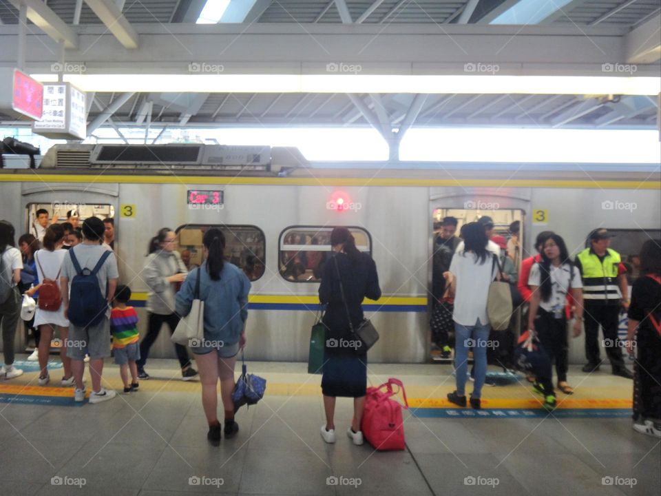 The train is entering the station.
Passengers getting on and off.
Overcrowded trains during commuting hours