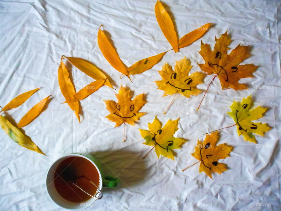 colorful autumn leaves and a cup of tea