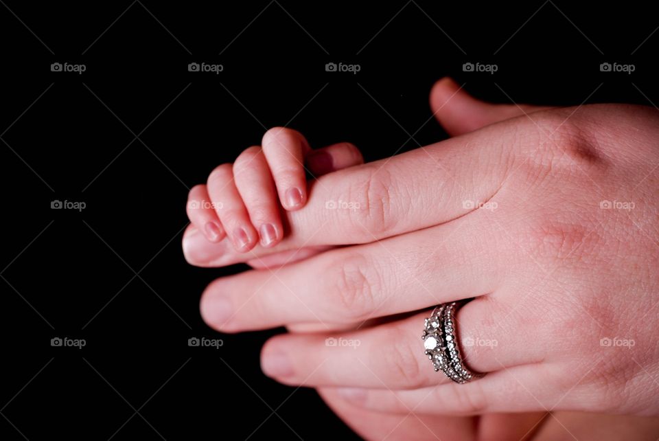 Mother holding baby's hand