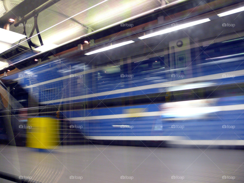 Reflection of indoors of metro on window mixed with motion blur while leaving metro station in Brussels, Belgium.